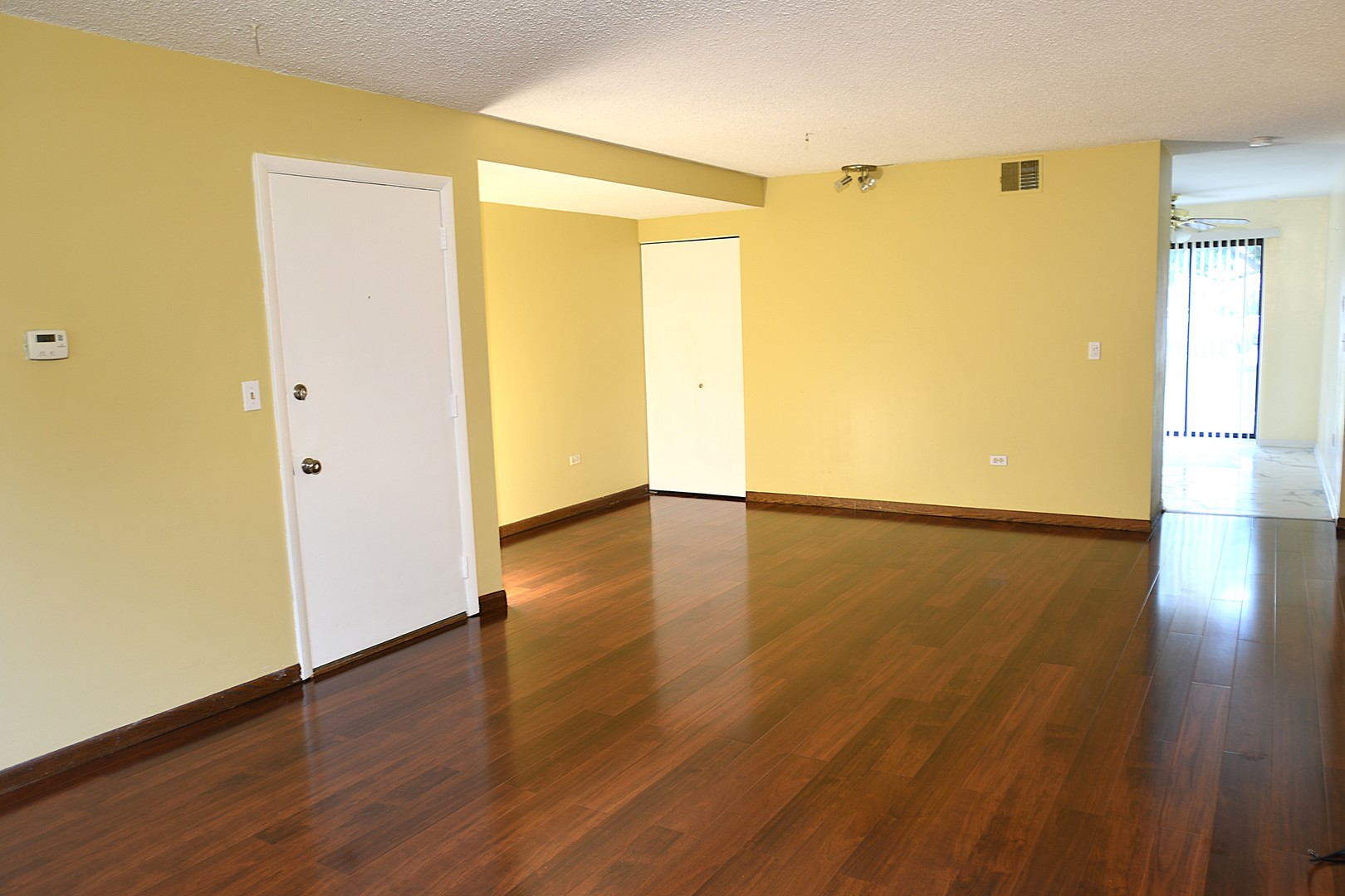 1472 Carol Court, Unit 1A Palatine, IL 60074 - Photo 7 of 11 an empty room with wooden floor