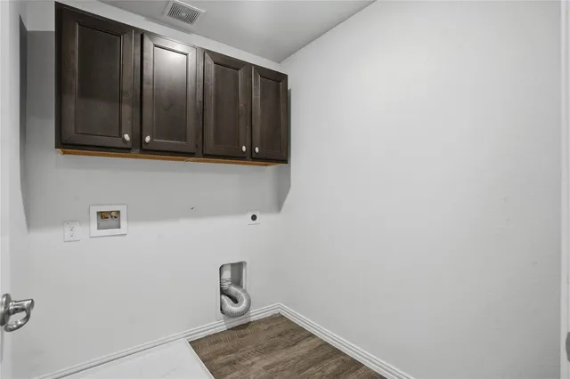 a view of storage and utility room with wooden floor