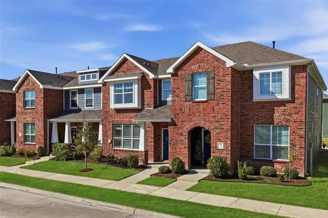 a front view of a house with yard and garage