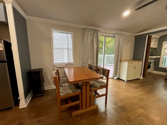 a dining room with furniture and wooden floor