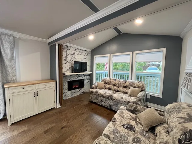 a living room with furniture fireplace and flat screen tv