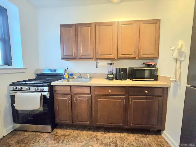 a kitchen with a sink cabinets and appliances