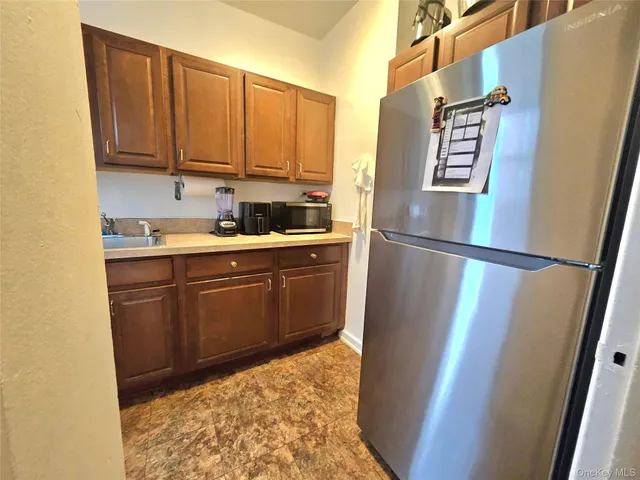 a kitchen with sink cabinets and refrigerator