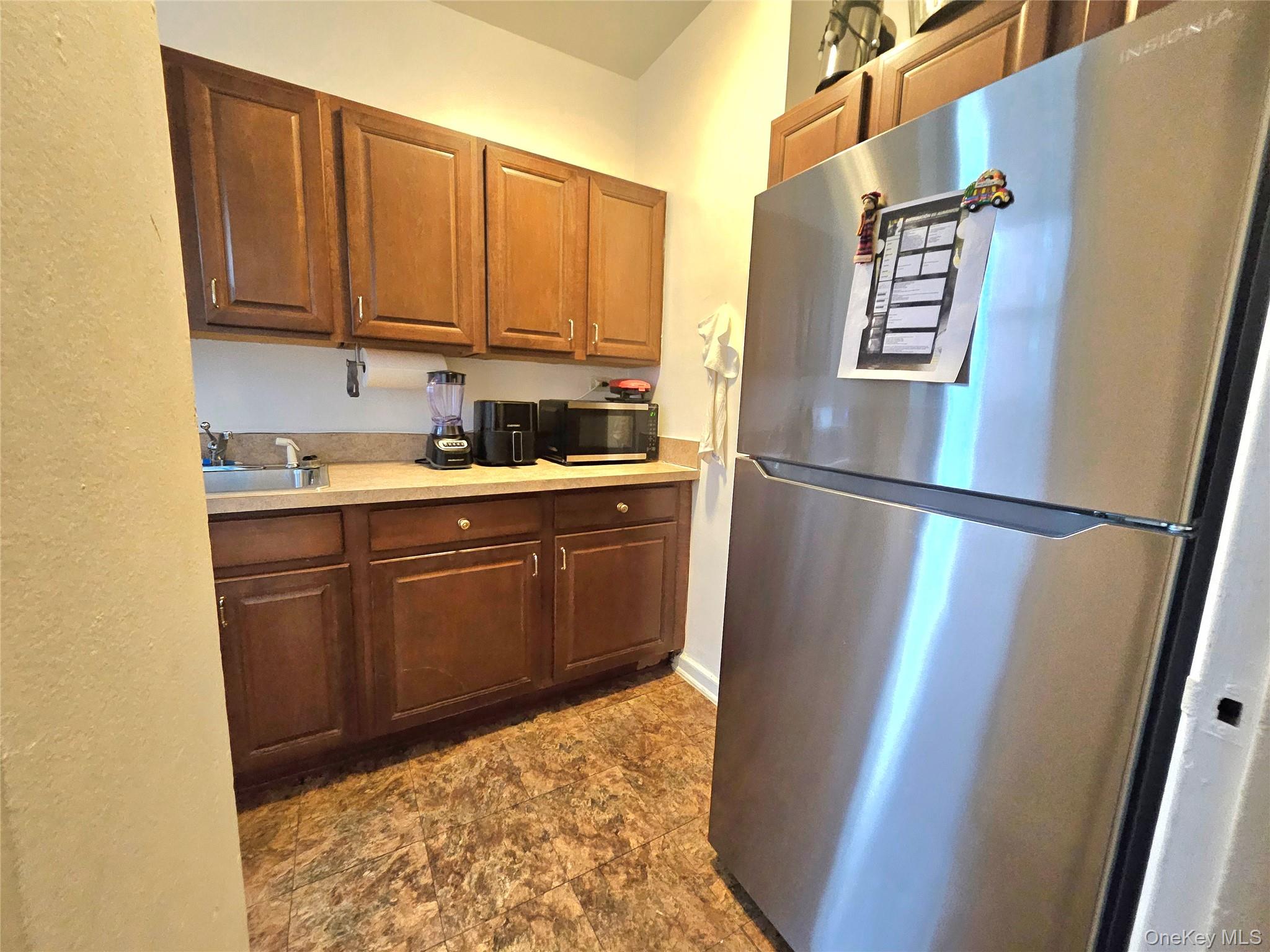 112-25 34th Avenue, Unit H Queens, NY 11368 - Photo 13 of 20 a kitchen with sink cabinets and refrigerator