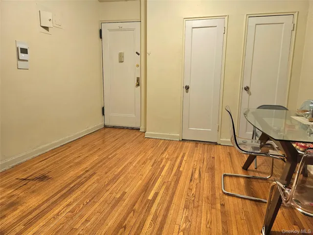 a view of a room with wooden floor
