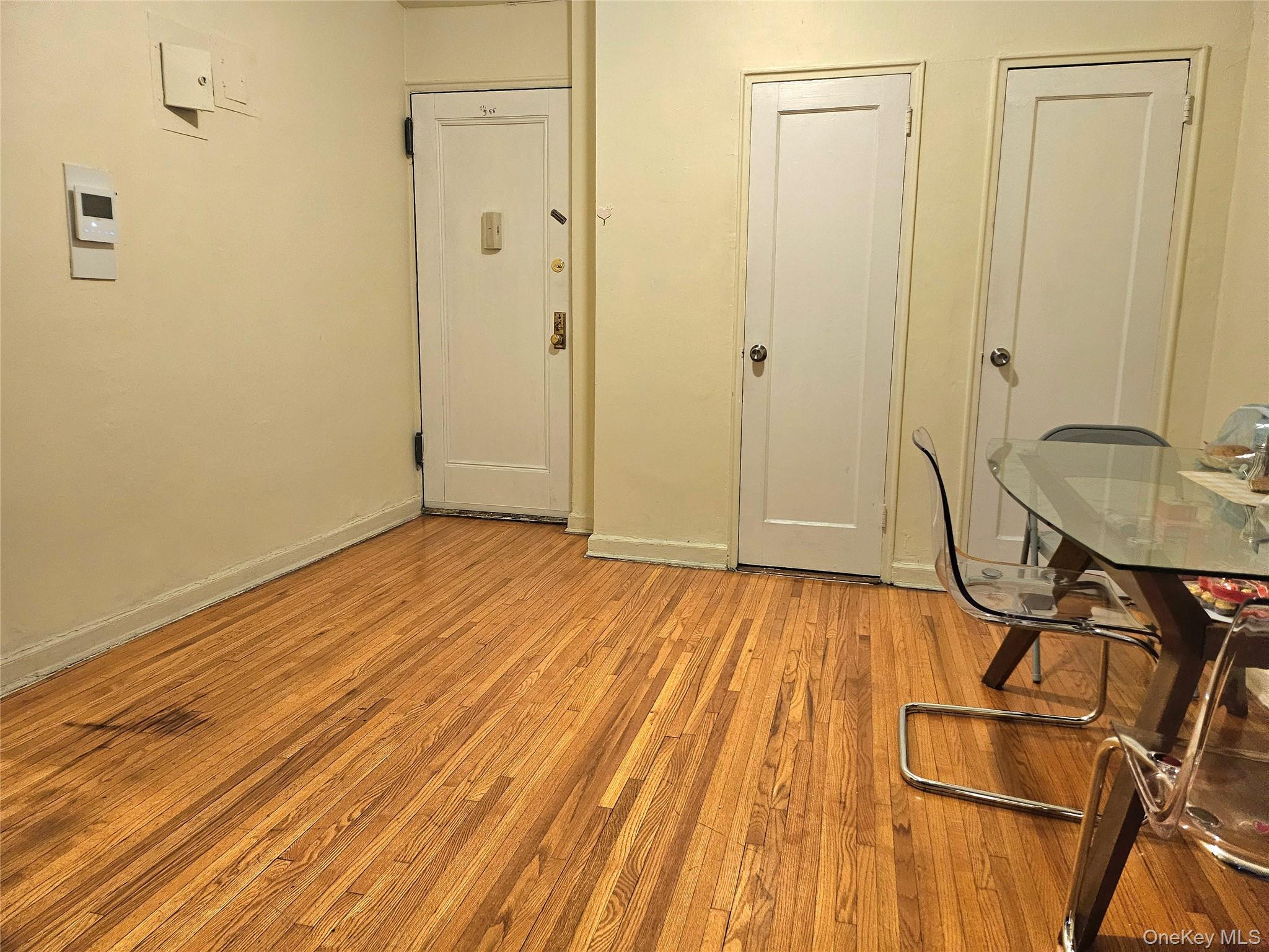 112-25 34th Avenue, Unit H Queens, NY 11368 - Photo 10 of 20 a view of a room with wooden floor