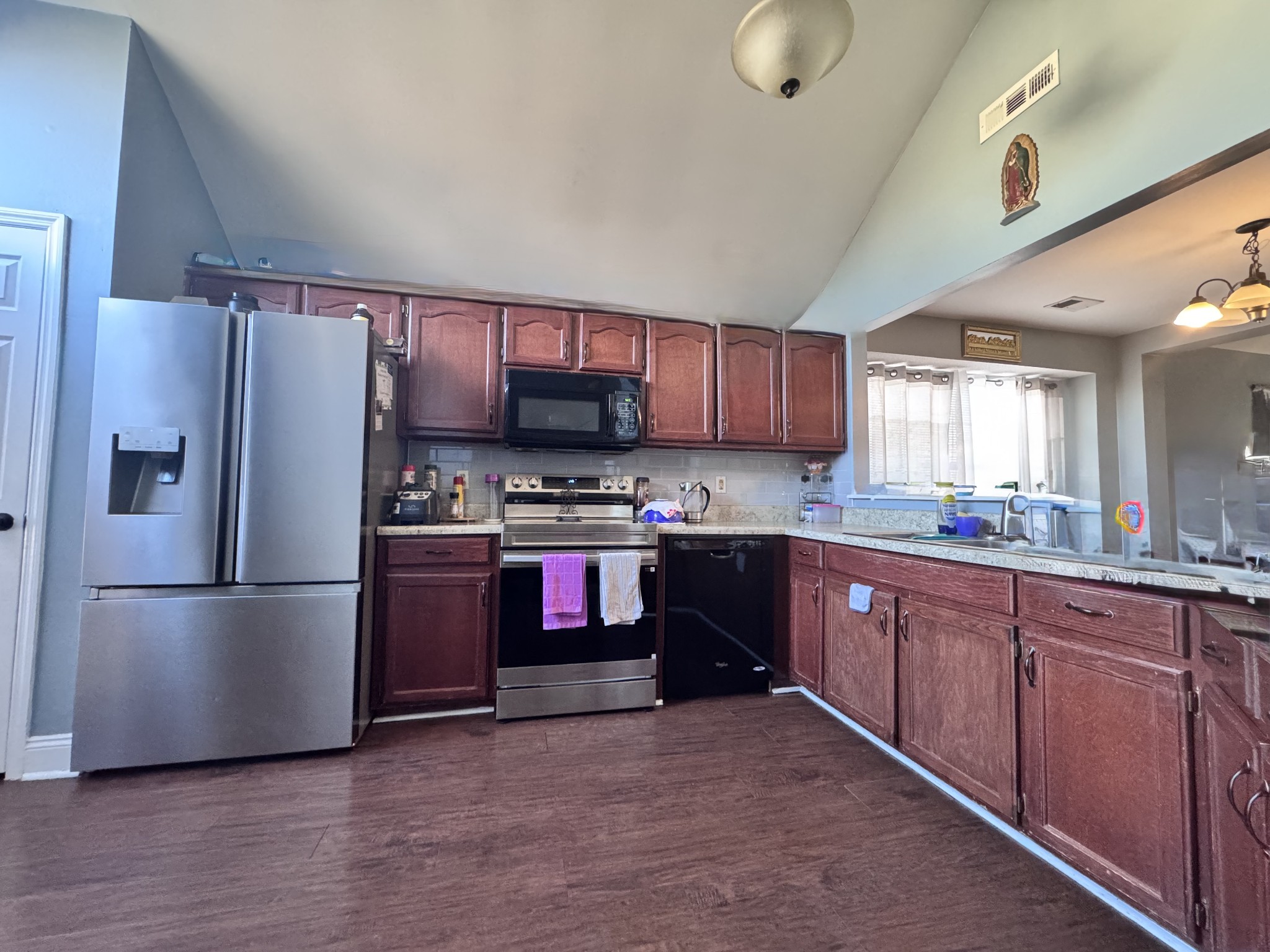 589 Hollandale Road La Vergne, TN 37086 - Photo 2 of 27 a kitchen with stainless steel appliances granite countertop a refrigerator stove and sink
