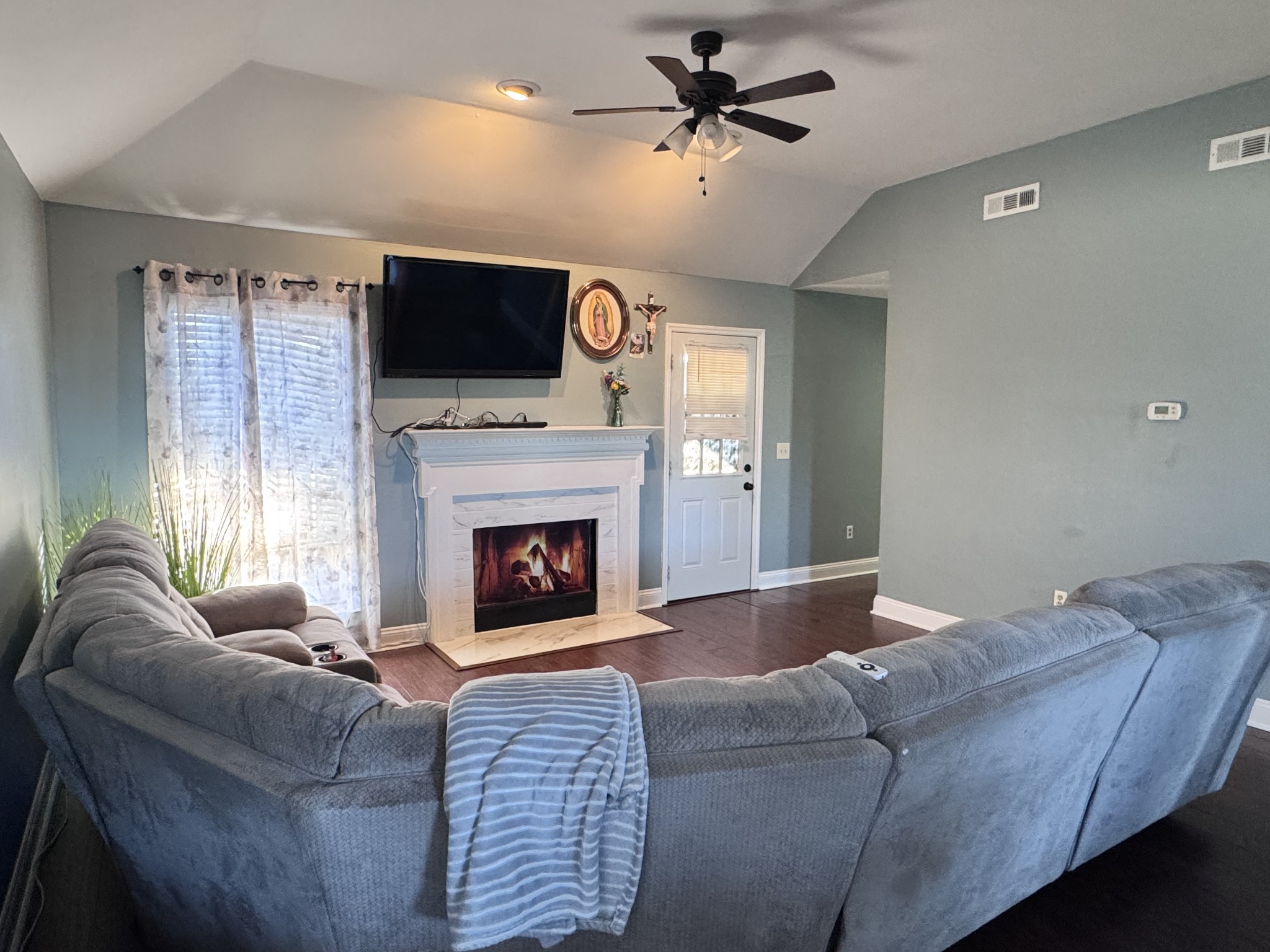 589 Hollandale Road La Vergne, TN 37086 - Photo 8 of 27 a living room with furniture a fireplace and a flat screen tv