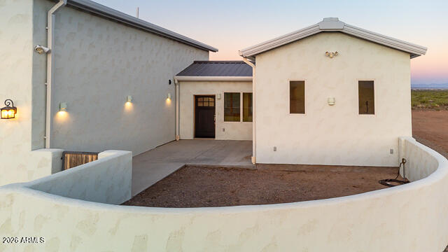 6233 West Airport Road Willcox, AZ 85643 - Photo 12 of 54 a view of a white house next to a yard