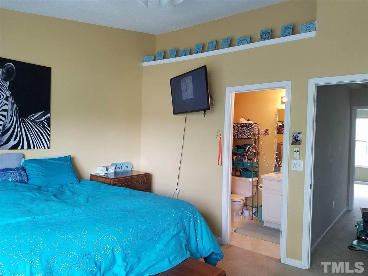 5462 Patuxent Drive Raleigh, NC 27616 - Photo 15 of 25 a bedroom with a bed and a television