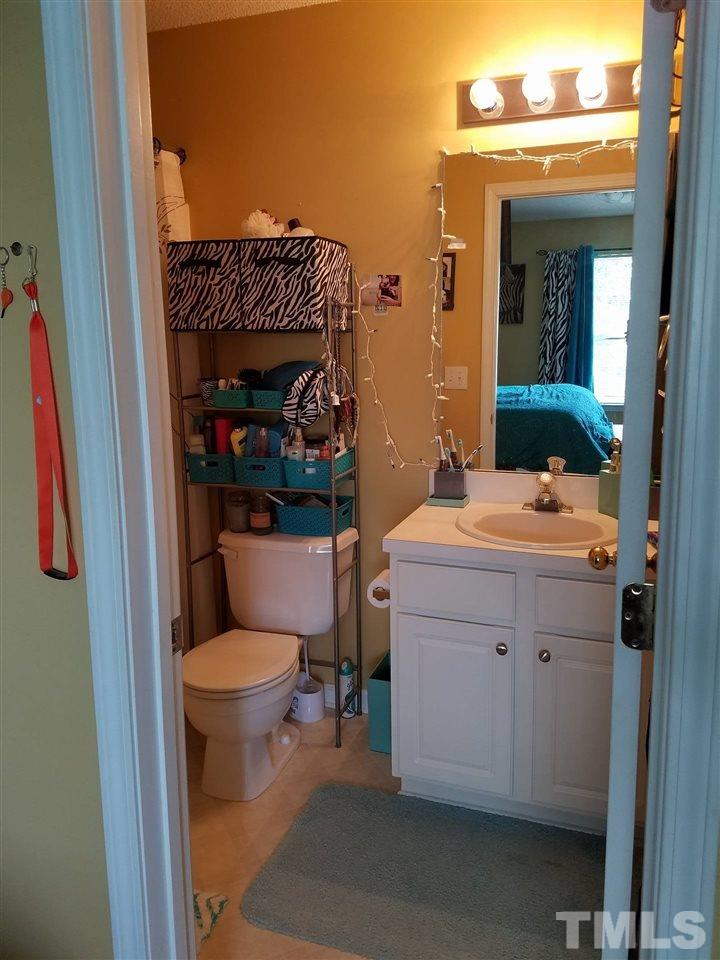 5462 Patuxent Drive Raleigh, NC 27616 - Photo 17 of 25 a bathroom with a sink a toilet and shower