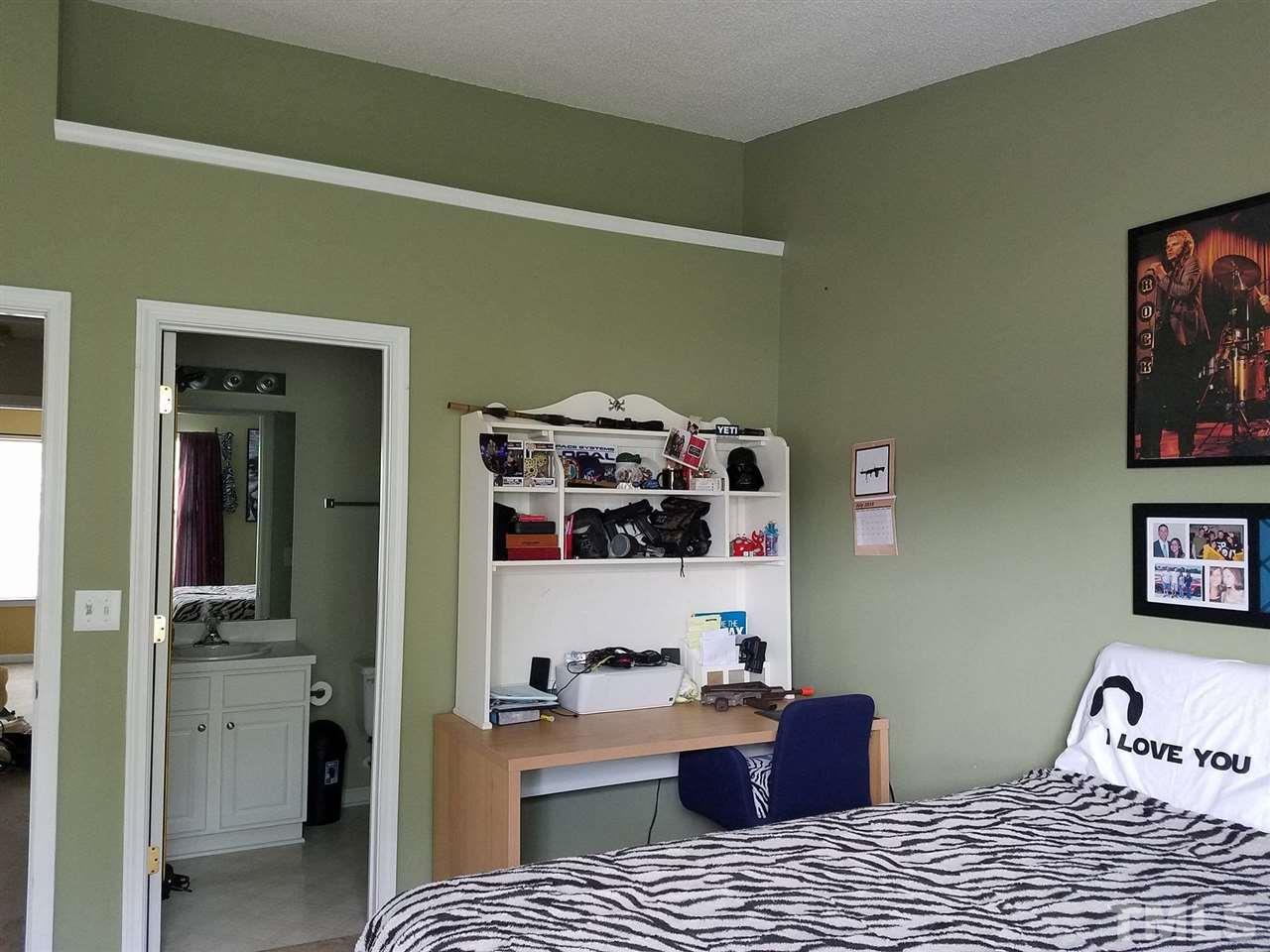 5462 Patuxent Drive Raleigh, NC 27616 - Photo 18 of 25 a bedroom with a bed and cabinets