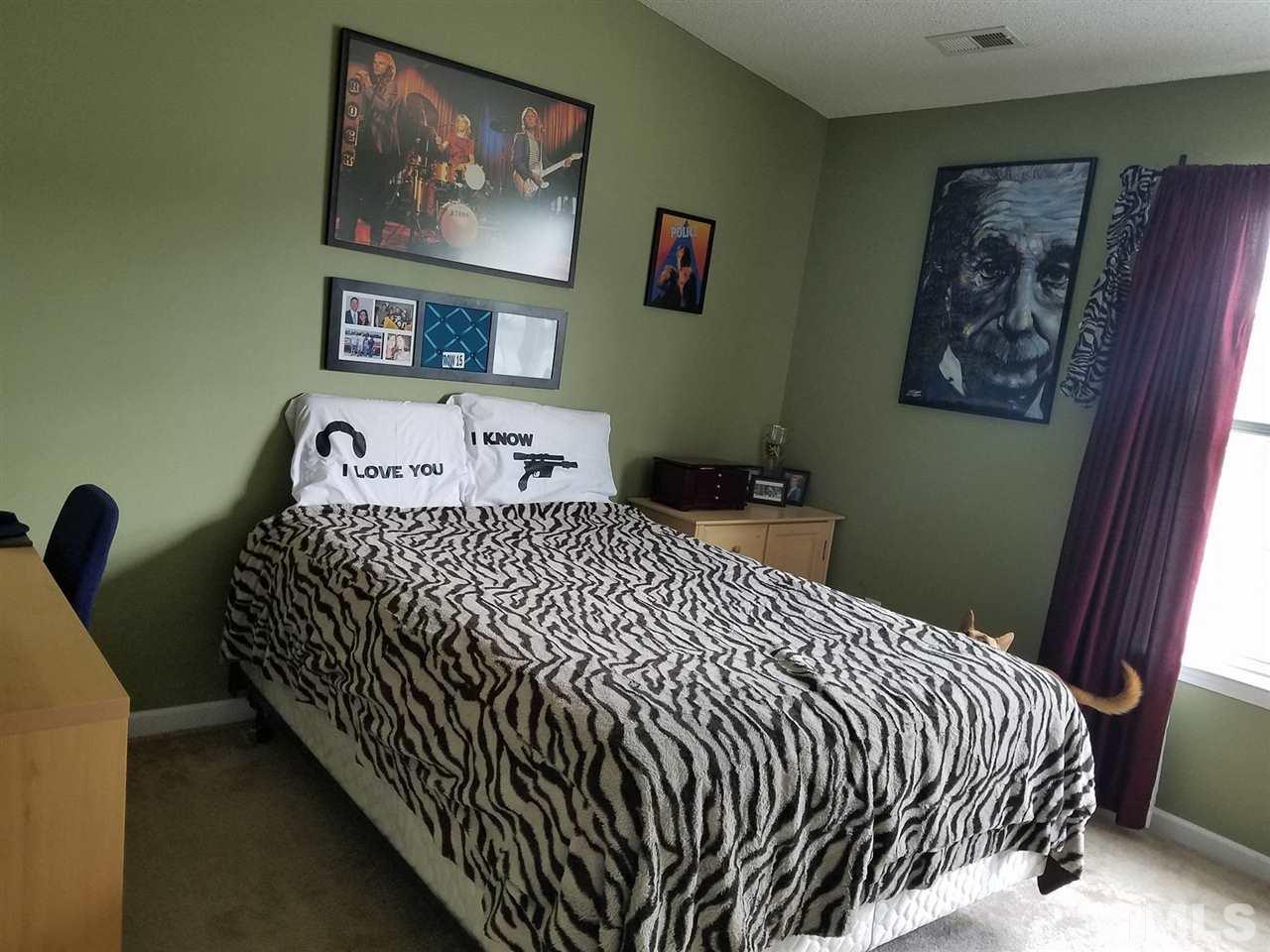 5462 Patuxent Drive Raleigh, NC 27616 - Photo 19 of 25 a bedroom with bed and cupboard