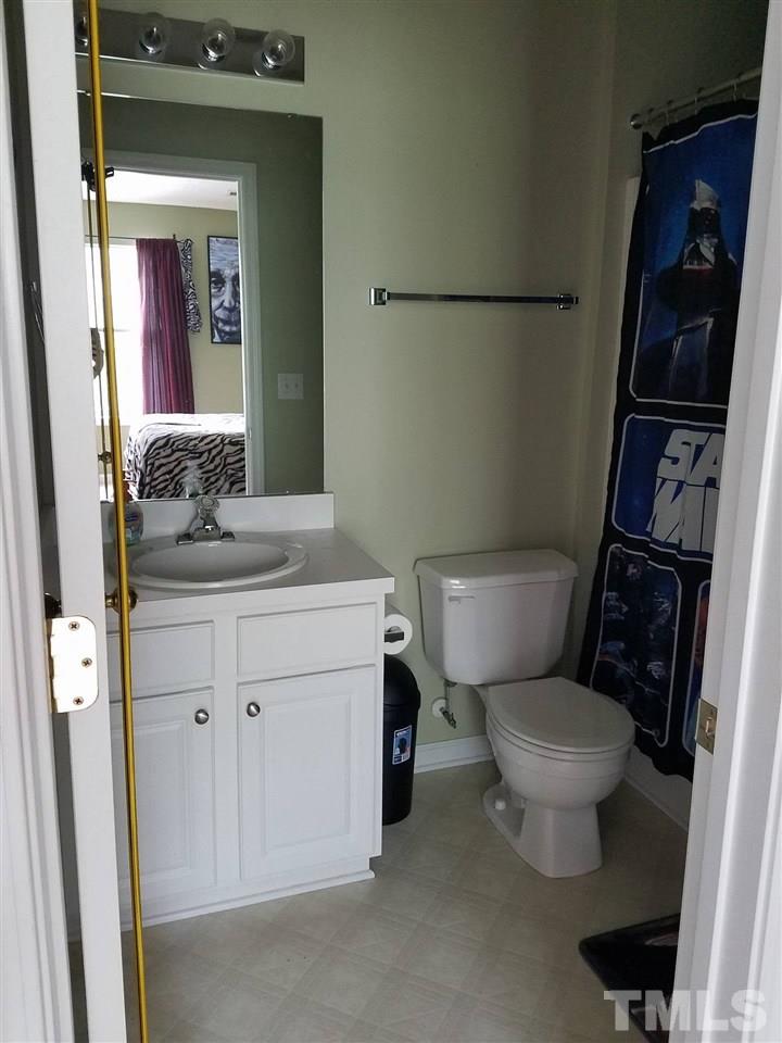 5462 Patuxent Drive Raleigh, NC 27616 - Photo 20 of 25 a bathroom with a granite countertop toilet sink and mirror