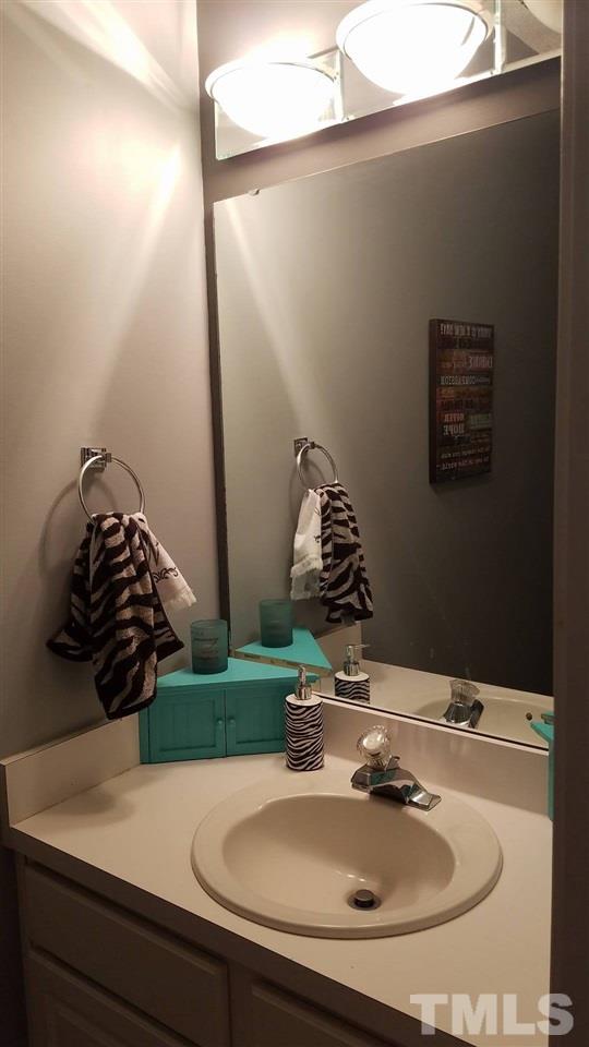 5462 Patuxent Drive Raleigh, NC 27616 - Photo 5 of 25 a bathroom with a sink and a mirror