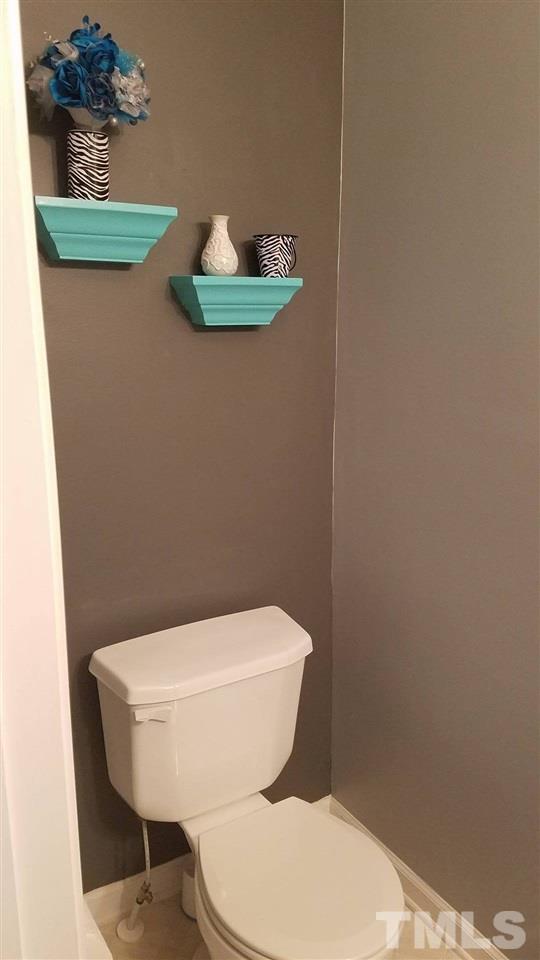 5462 Patuxent Drive Raleigh, NC 27616 - Photo 6 of 25 a white toilet sitting next to a sink