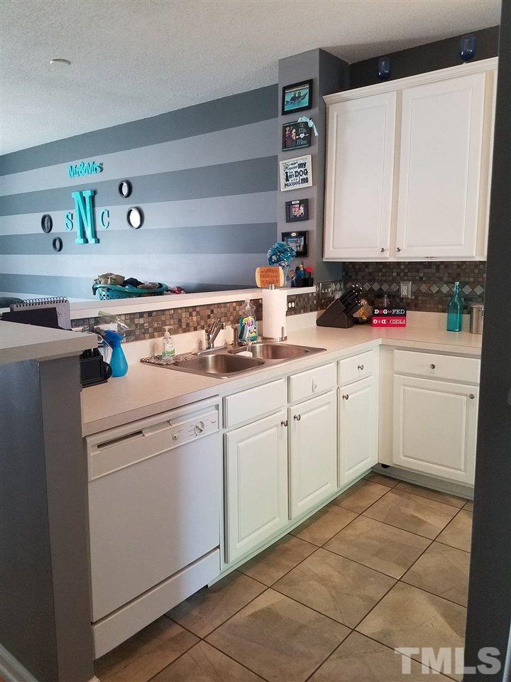 5462 Patuxent Drive Raleigh, NC 27616 - Photo 8 of 25 a utility room with cabinets washer and dryer