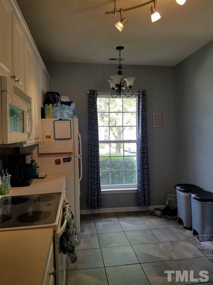 5462 Patuxent Drive Raleigh, NC 27616 - Photo 9 of 25 a kitchen that has a stove and a microwave
