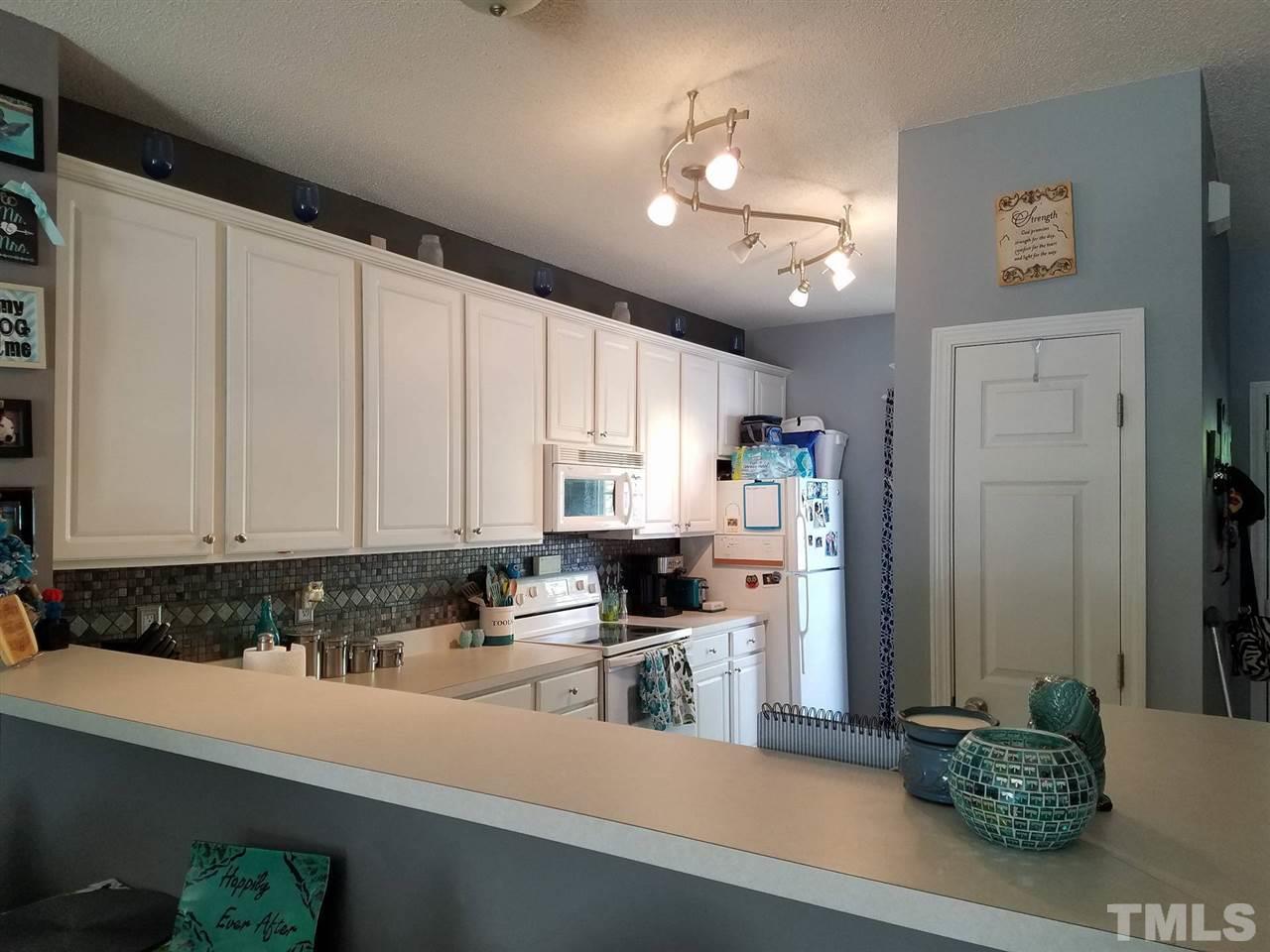 5462 Patuxent Drive Raleigh, NC 27616 - Photo 10 of 25 a kitchen with stainless steel appliances a refrigerator sink and cabinets