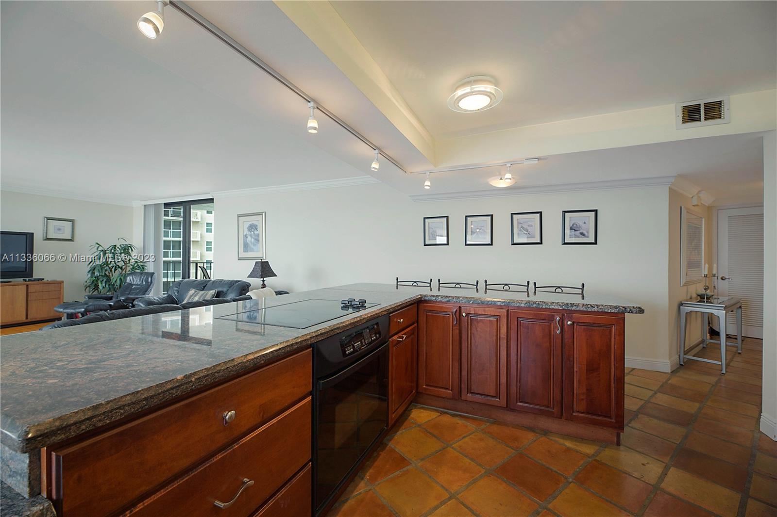 5420 North Ocean Drive, Unit 1205 Riviera Beach, FL 33404 - Photo 16 of 76 a kitchen with stainless steel appliances granite countertop a sink and dishwasher cabinets