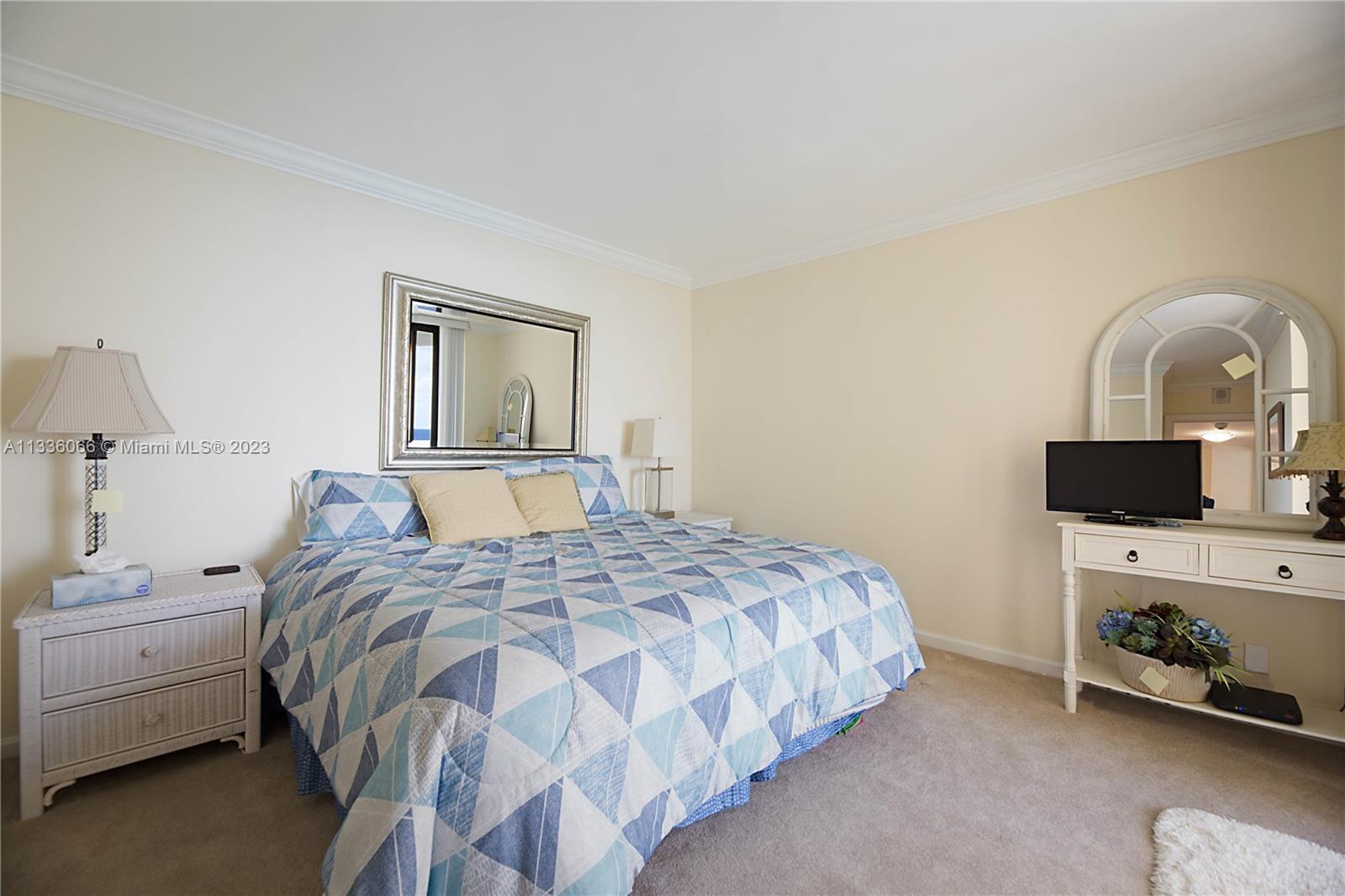 5420 North Ocean Drive, Unit 1205 Riviera Beach, FL 33404 - Photo 23 of 76 a bedroom with a bed and a tv on the dresser