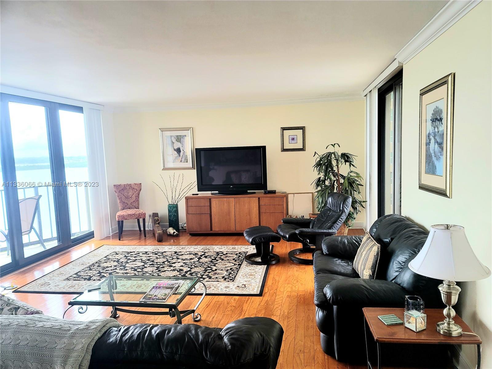 5420 North Ocean Drive, Unit 1205 Riviera Beach, FL 33404 - Photo 33 of 76 a living room with furniture and a flat screen tv