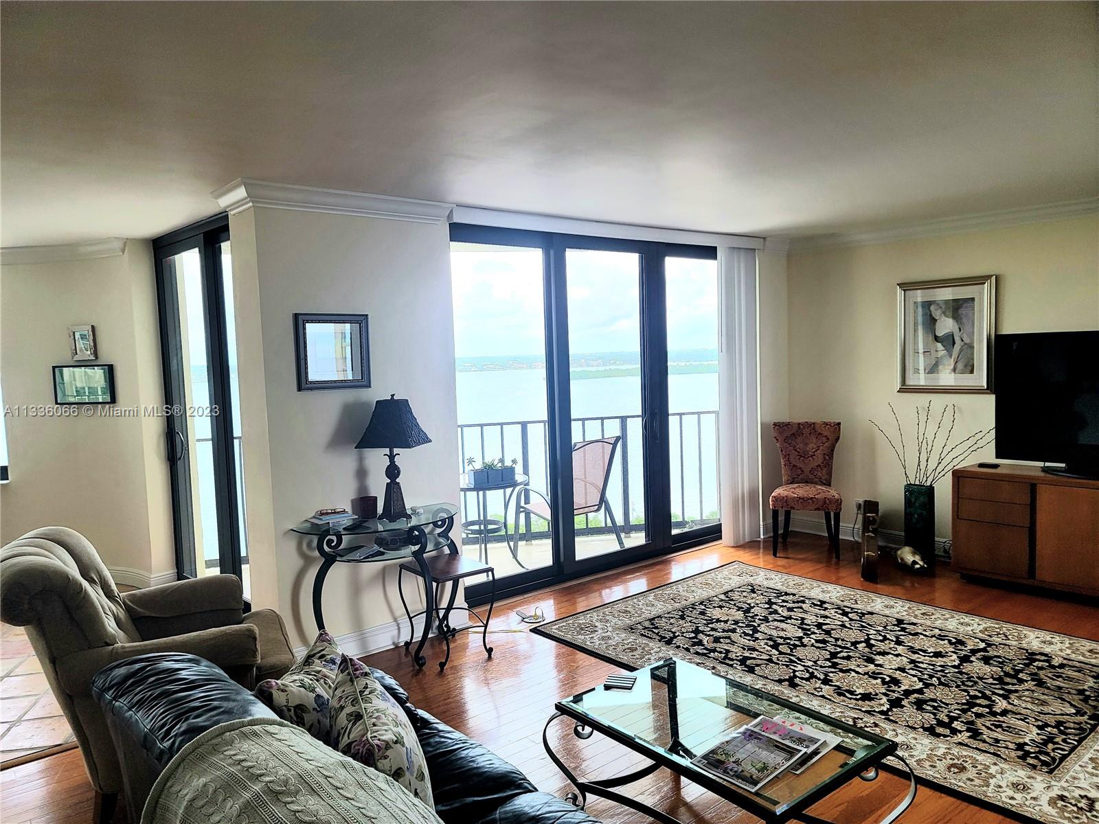 5420 North Ocean Drive, Unit 1205 Riviera Beach, FL 33404 - Photo 34 of 76 a living room with furniture floor to ceiling window and a flat screen tv