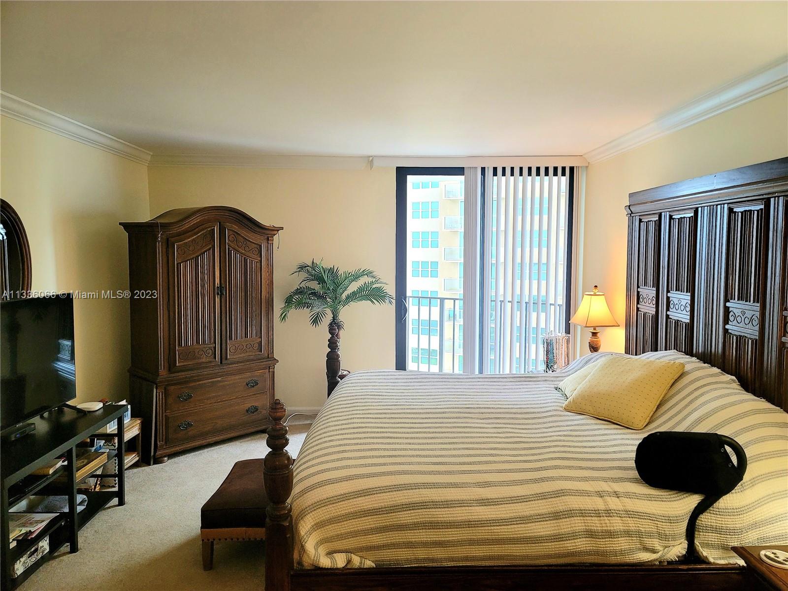 5420 North Ocean Drive, Unit 1205 Riviera Beach, FL 33404 - Photo 41 of 76 a bedroom with a bed and a television