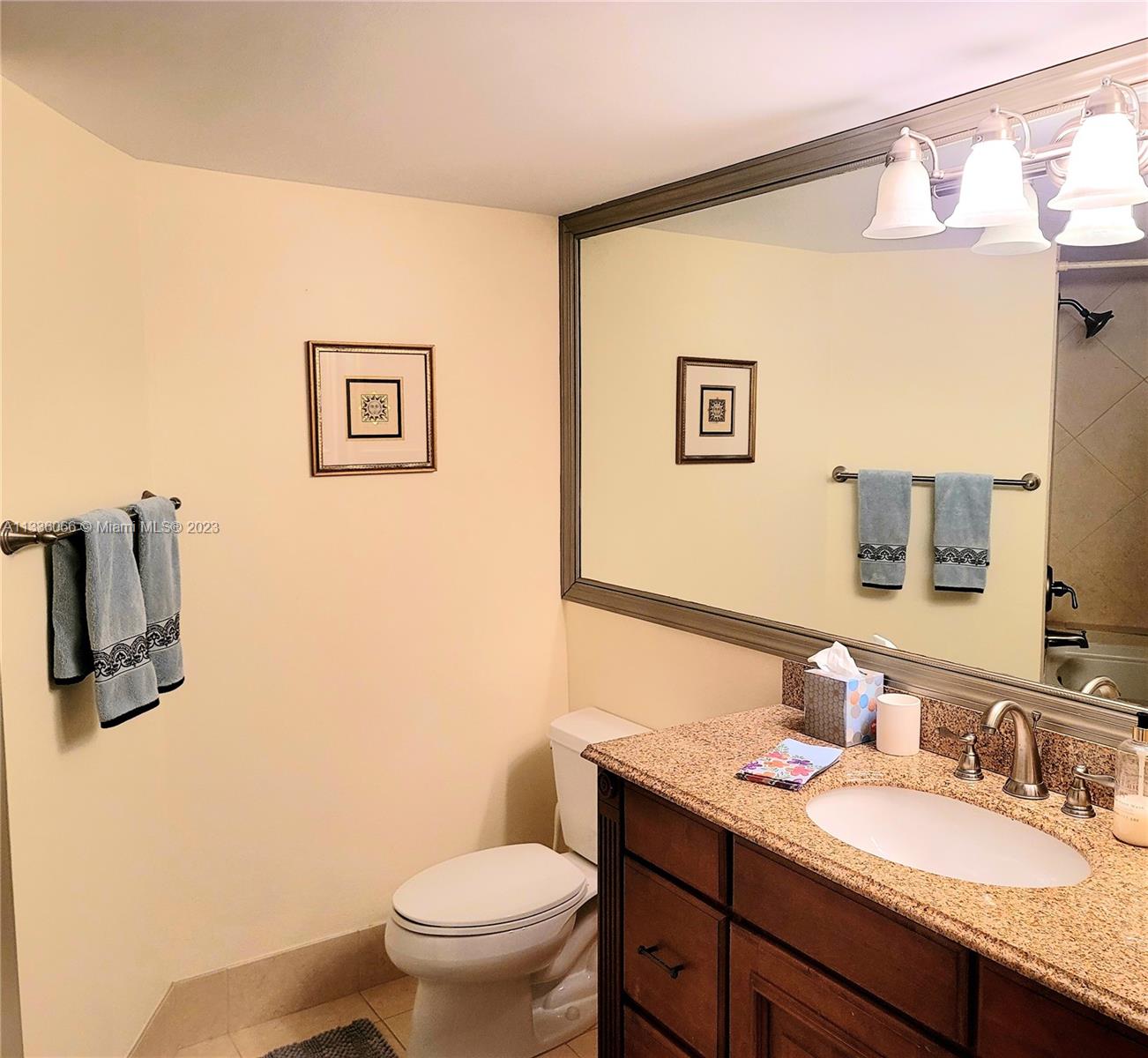 5420 North Ocean Drive, Unit 1205 Riviera Beach, FL 33404 - Photo 42 of 76 a bathroom with a granite countertop sink mirror vanity and toilet