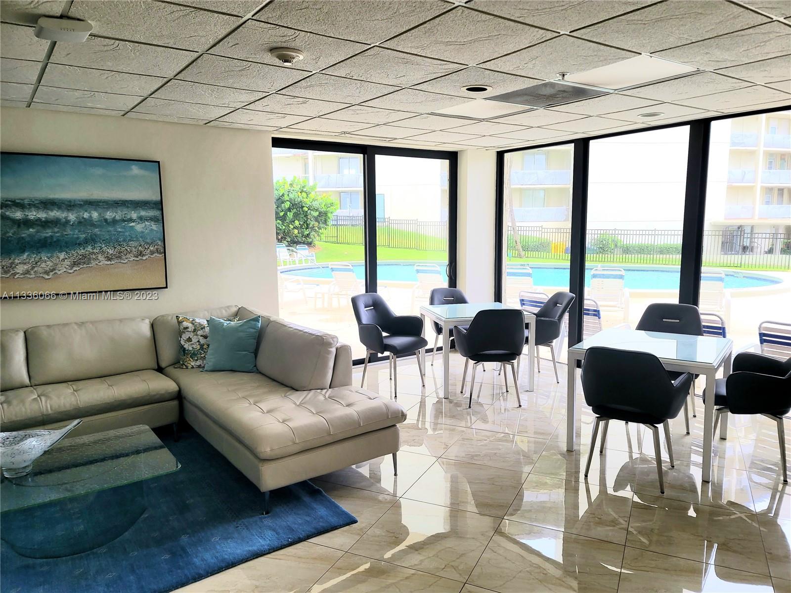 5420 North Ocean Drive, Unit 1205 Riviera Beach, FL 33404 - Photo 47 of 76 a living room with furniture and a floor to ceiling window