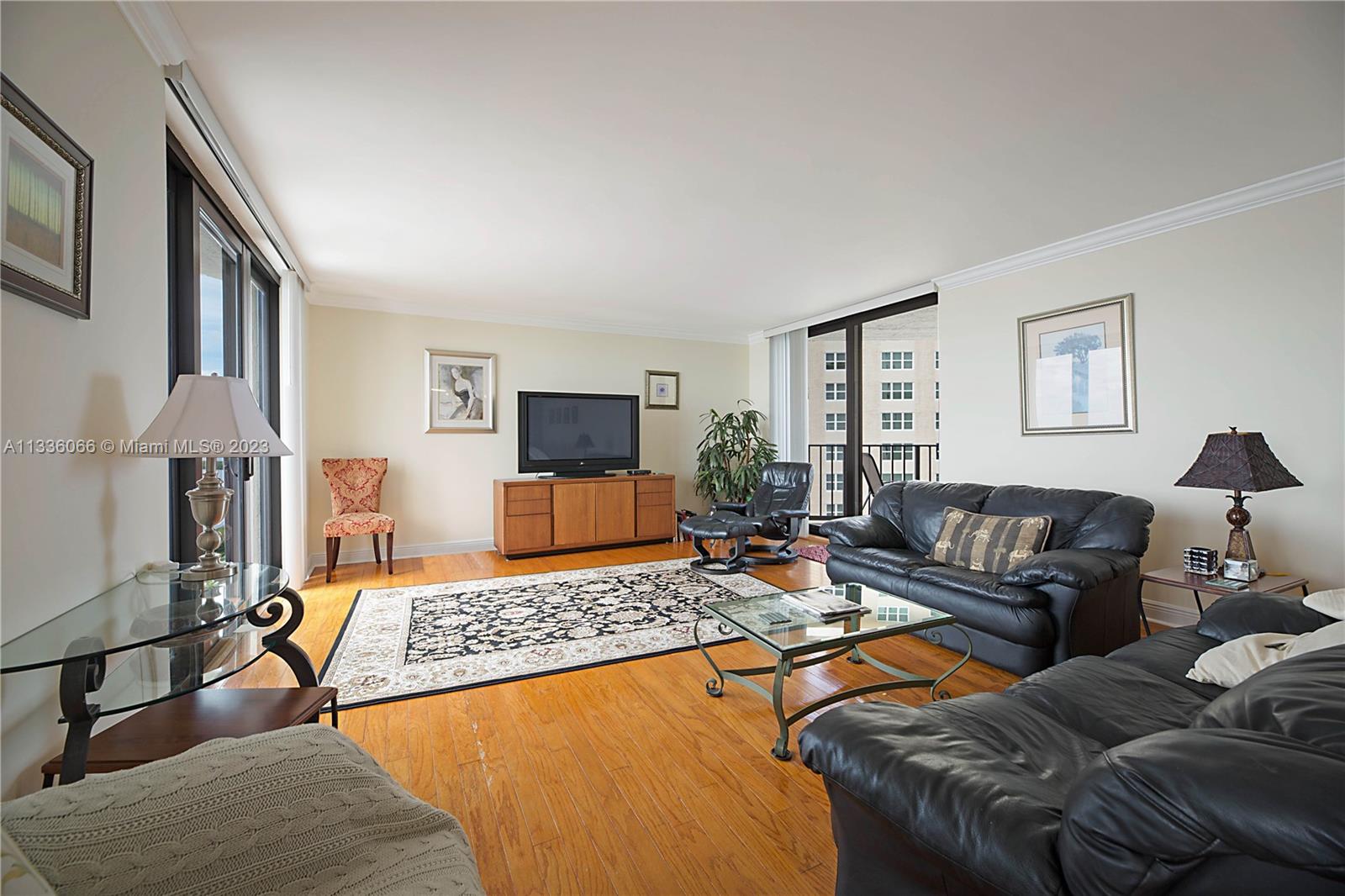 5420 North Ocean Drive, Unit 1205 Riviera Beach, FL 33404 - Photo 10 of 76 a living room with furniture and a flat screen tv