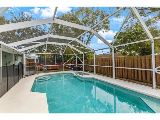 a view of a backyard with table and chairs