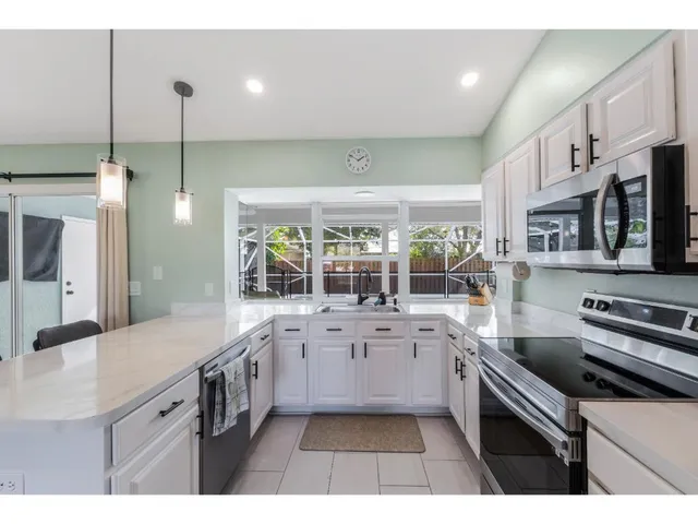 a kitchen with stainless steel appliances granite countertop a sink and stove