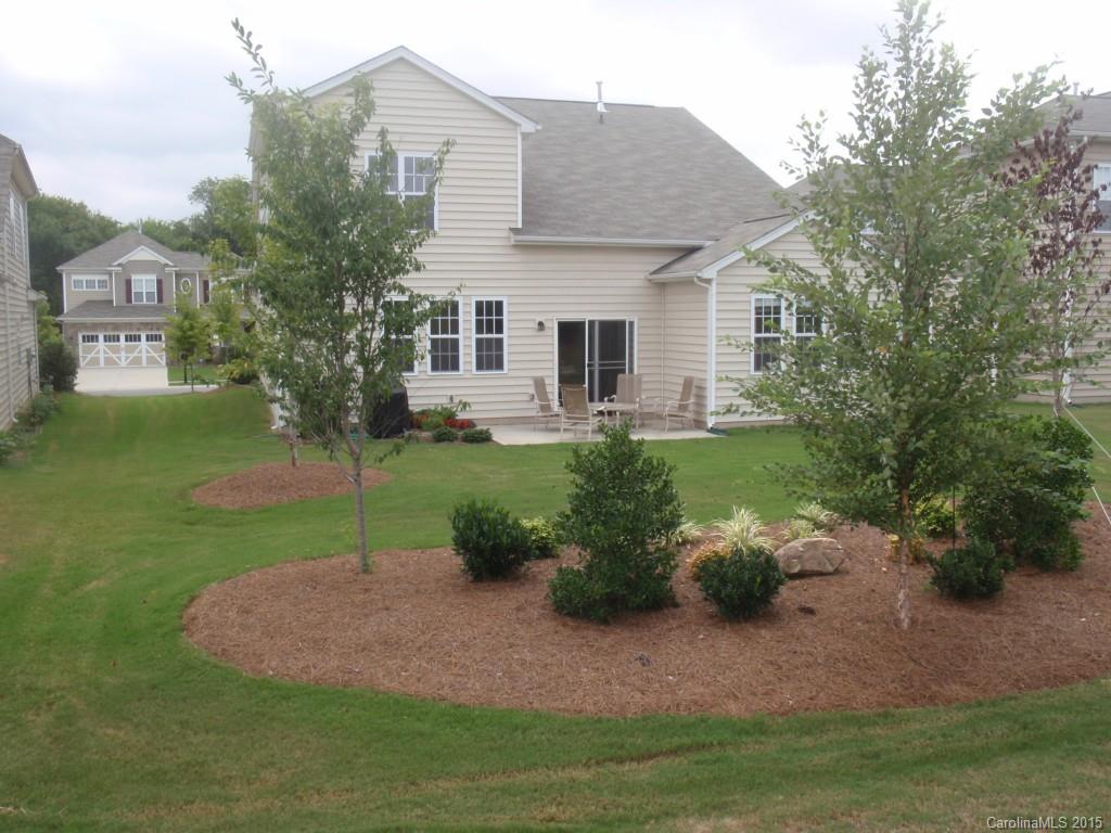 5722 Cactus Valley Road Charlotte, NC 28277 - Photo 2 of 18 a backyard of a house with plants and large tree