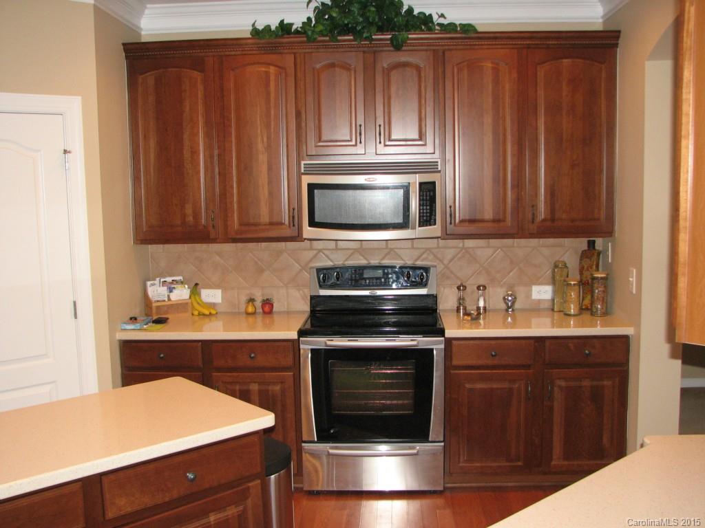 5722 Cactus Valley Road Charlotte, NC 28277 - Photo 7 of 18 a kitchen with granite countertop wood cabinets and stainless steel appliances