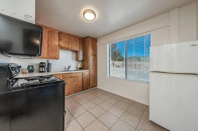 a kitchen with stainless steel appliances granite countertop a sink counter space and cabinets