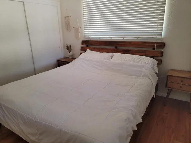 a bedroom with a bed and a window