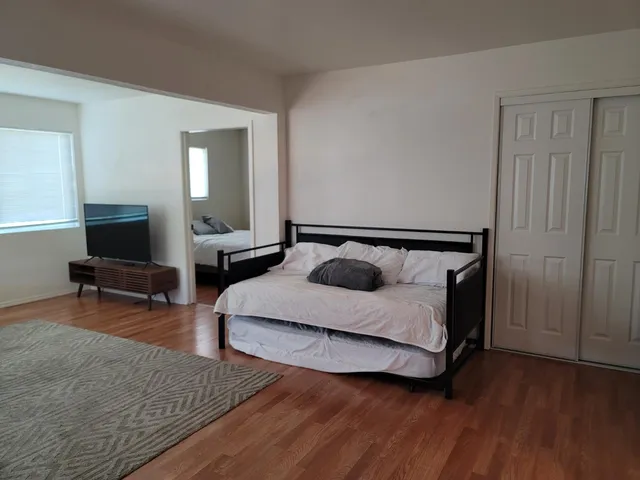 a bedroom with a bed and a painting on the wall