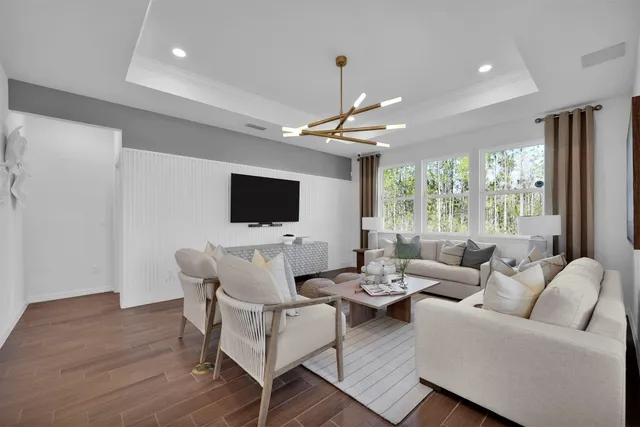 a living room with furniture wooden floor and a flat screen tv