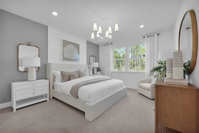 a spacious bedroom with a bed and a chandelier