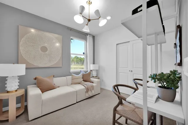 a living room with furniture potted plant and a chandelier