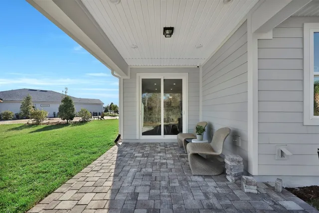 a living room with patio furniture and garden