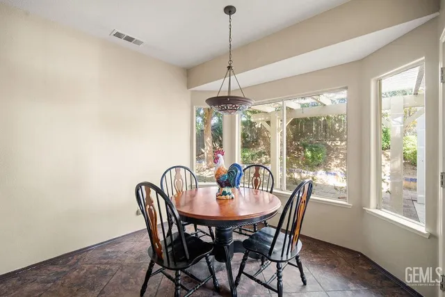 a dining room with furniture window and outside view