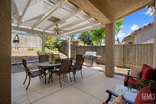 a view of a patio with table and chairs and potted plants