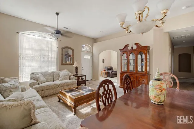 a living room with furniture a chandelier and a window