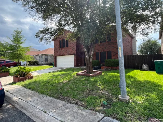a view of a house with a yard and tree s