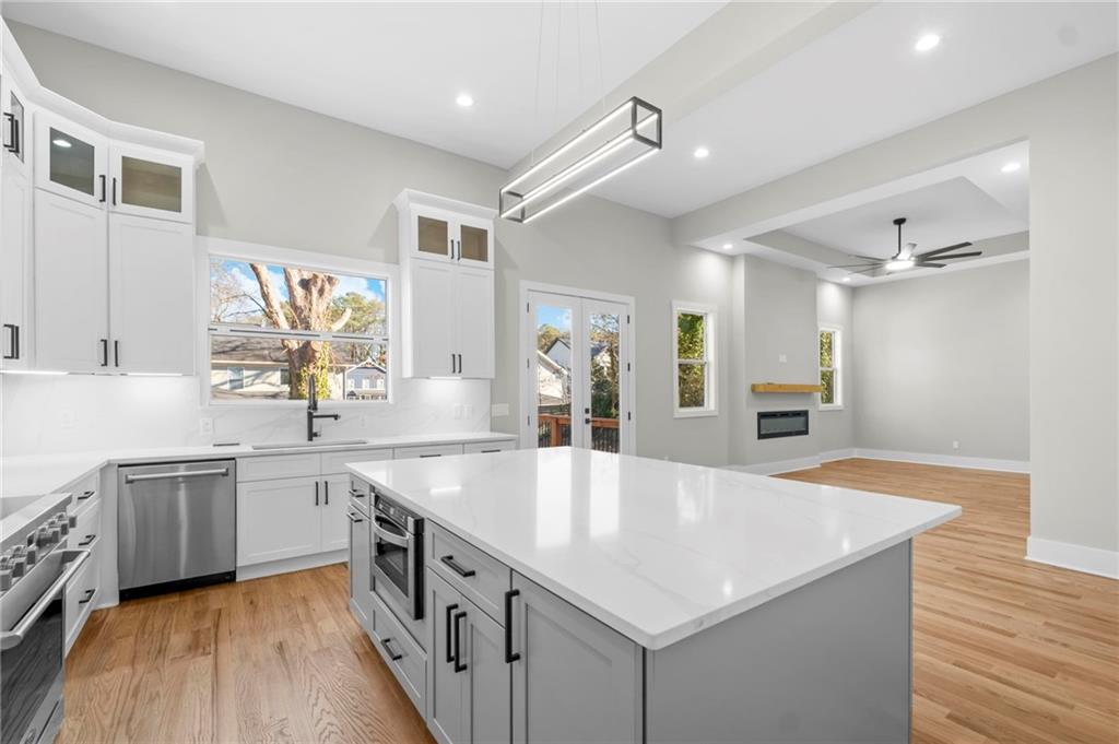 363 Marigna Avenue Scottdale, GA 30079 - Photo 12 of 33 a large kitchen with stainless steel appliances lots of counter space and wooden floor