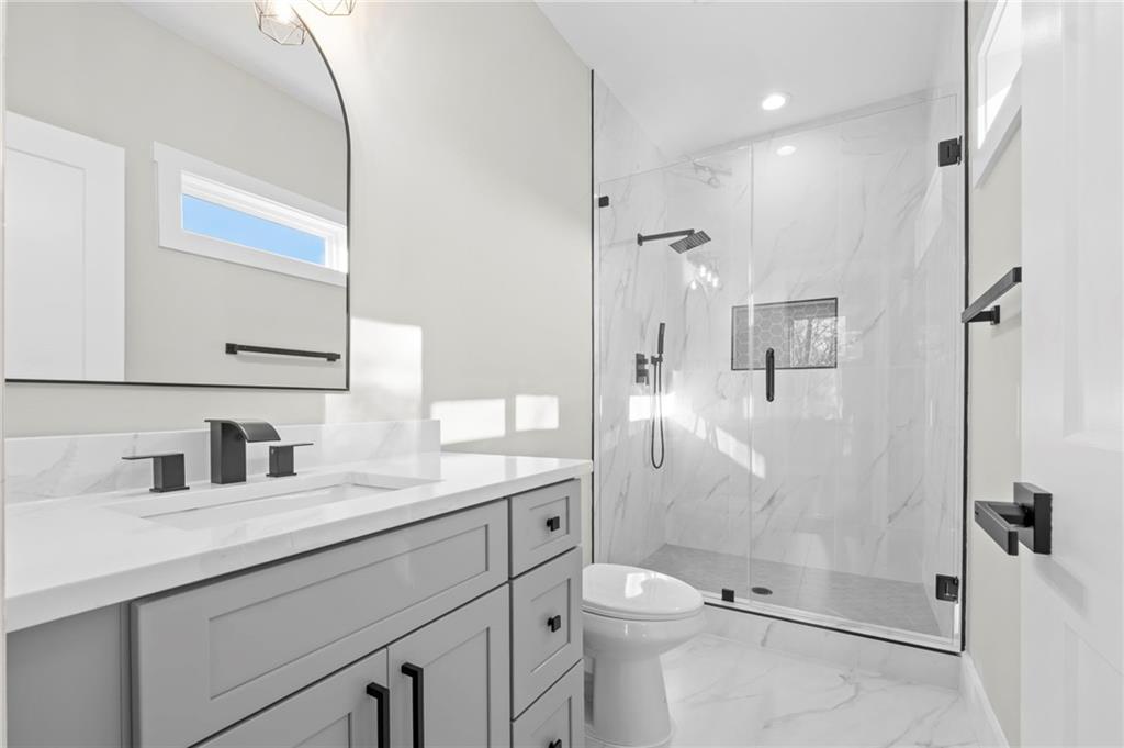 363 Marigna Avenue Scottdale, GA 30079 - Photo 23 of 33 a bathroom with a shower sink vanity mirror and toilet