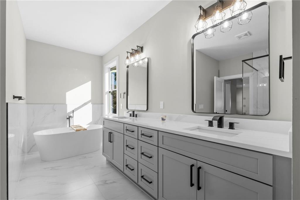 363 Marigna Avenue Scottdale, GA 30079 - Photo 28 of 33 a bathroom with a double vanity sink mirror double and bathtub