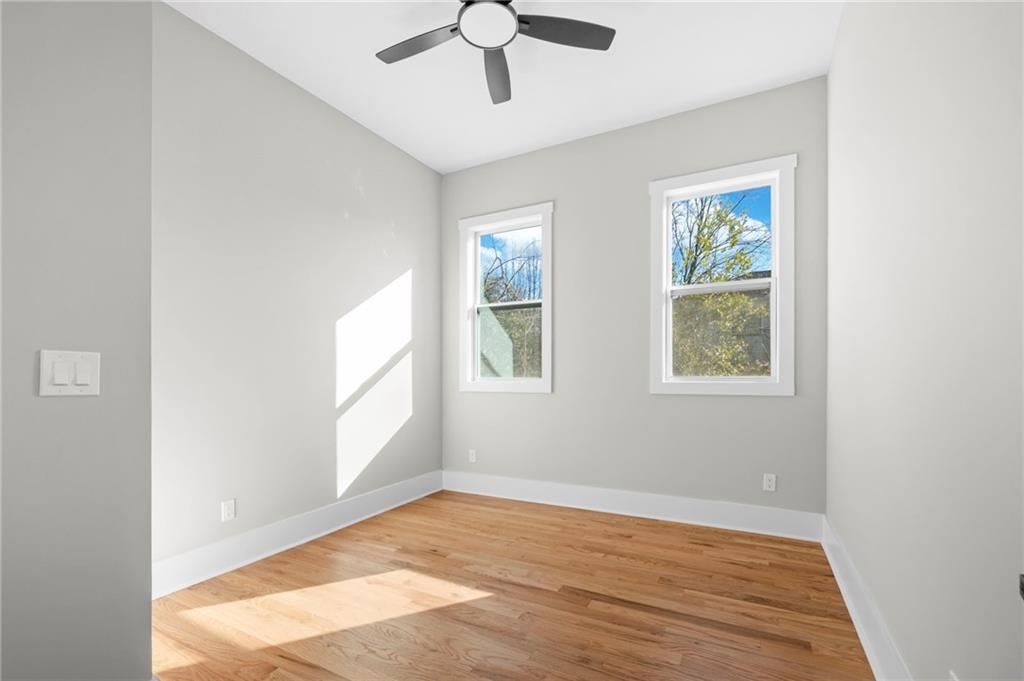 363 Marigna Avenue Scottdale, GA 30079 - Photo 7 of 33 a view of an empty room with wooden floor and a window
